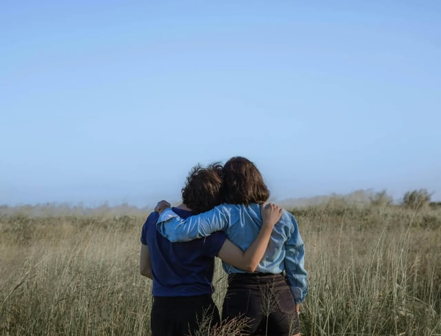 Couple hugging in wheat field
